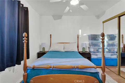 a bedroom with a large bed and a chandelier