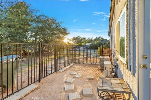 a view of a balcony with a floor to ceiling window next to a yard