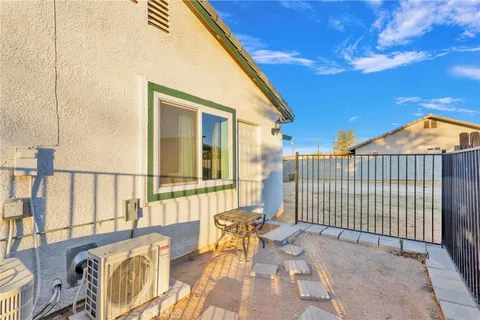 a view of a patio with a table and chairs