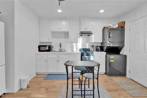 a kitchen with stainless steel appliances granite countertop a stove a sink a microwave a refrigerator and cabinets