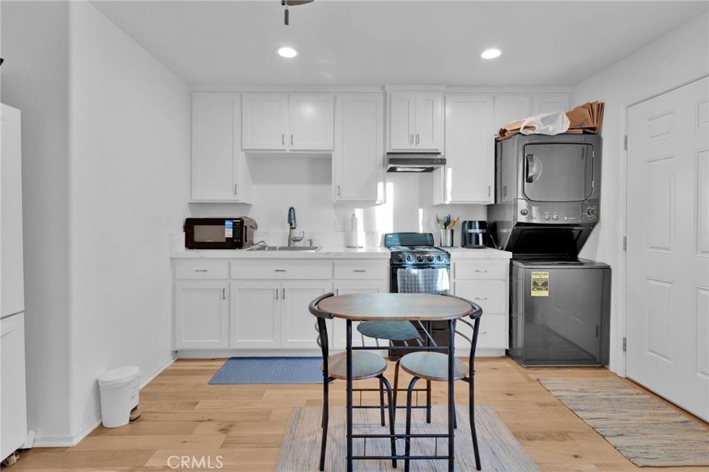 12887 Sholic Road Apple Valley, CA 92308 - Photo 27 of 47 a kitchen with stainless steel appliances granite countertop a stove a sink a microwave a refrigerator and cabinets
