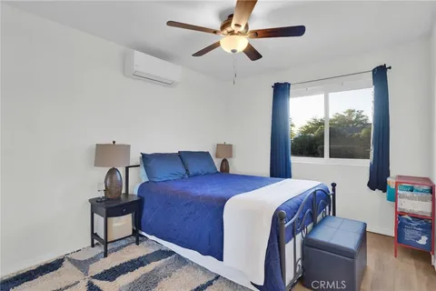 a bedroom with a large bed and a window