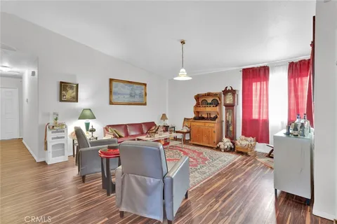 a room with furniture a window and wooden floor