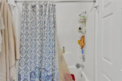 a bathroom with a bathtub and shower curtain
