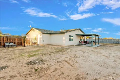 a view of a house with backyard space and balcony