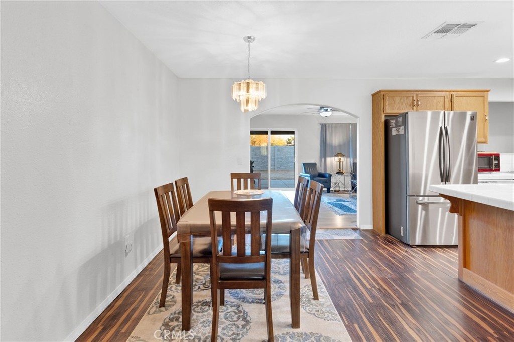 12887 Sholic Road Apple Valley, CA 92308 - Photo 6 of 47 a view of a dining room with furniture and wooden floor