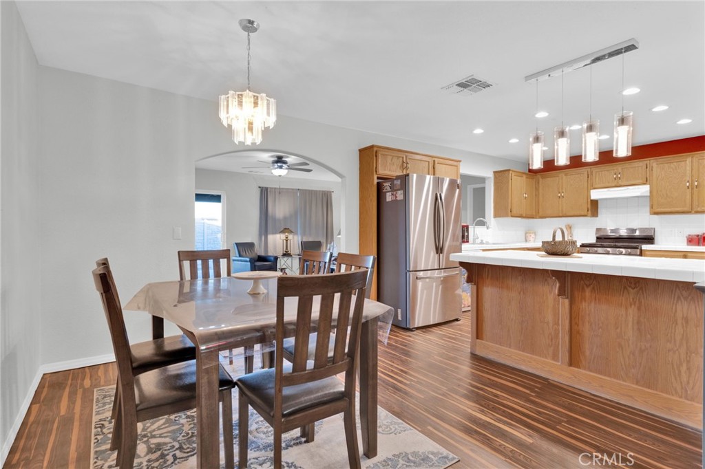 12887 Sholic Road Apple Valley, CA 92308 - Photo 7 of 47 a view of a dining room with furniture window and wooden floor