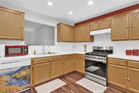 a kitchen with a sink stove and cabinets