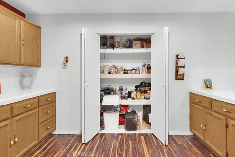 a hallway with wooden cabinets and wooden floor