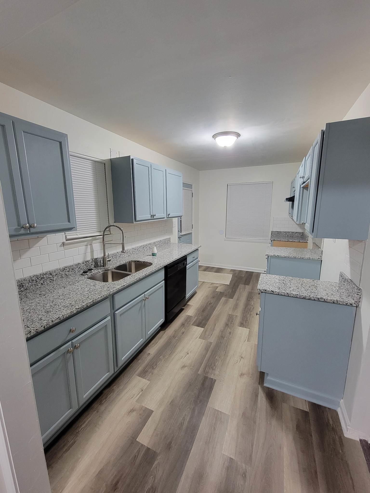 5424 Lochinvar Road Memphis, TN 38116 - Photo 6 of 20 a kitchen with granite countertop a sink stove and cabinets