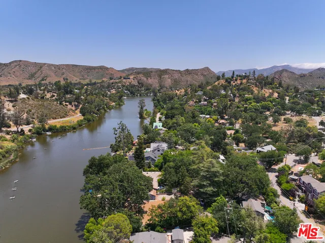 an aerial view of houses covered in trees