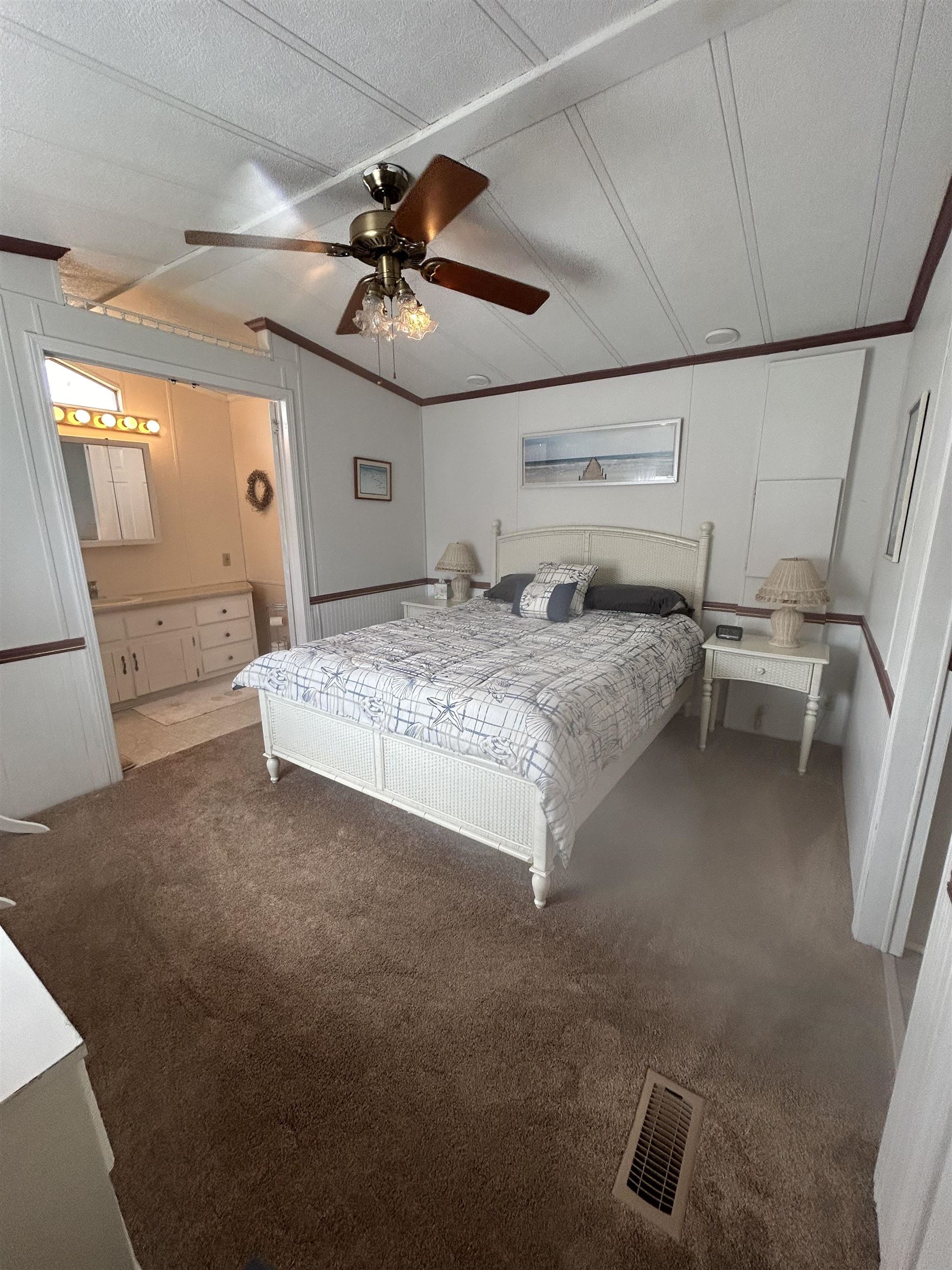 382 Grande Rio Grande, NJ 08242 - Photo 11 of 17 a spacious bedroom with a bed and a chandelier