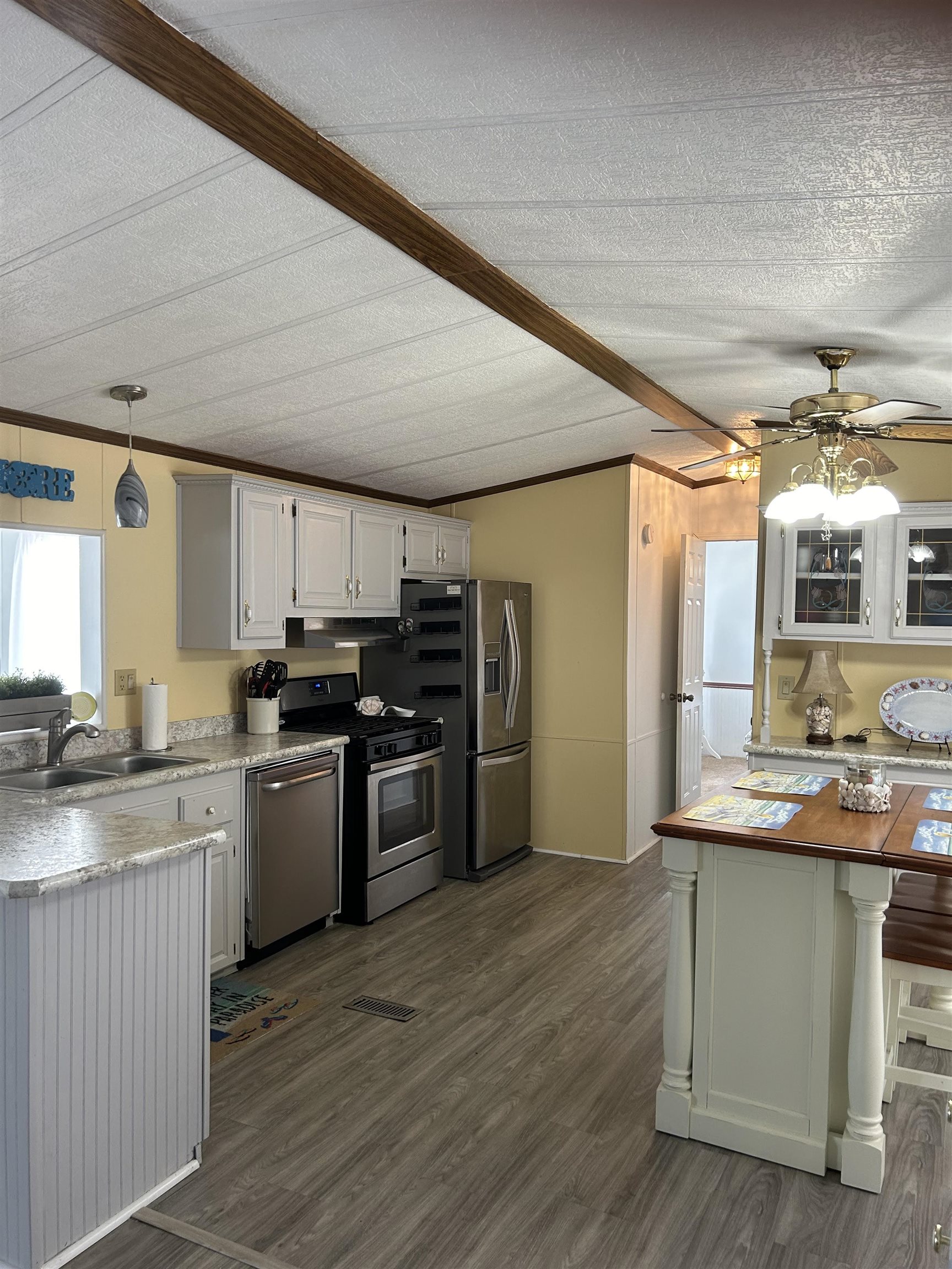 382 Grande Rio Grande, NJ 08242 - Photo 9 of 17 a kitchen with kitchen island granite countertop a sink cabinets and stainless steel appliances