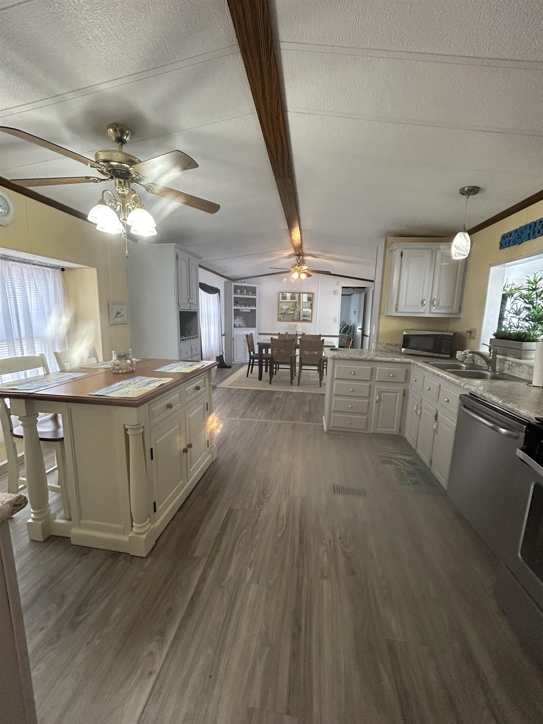 382 Grande Rio Grande, NJ 08242 - Photo 10 of 17 a kitchen with stainless steel appliances granite countertop a sink cabinets and wooden floor