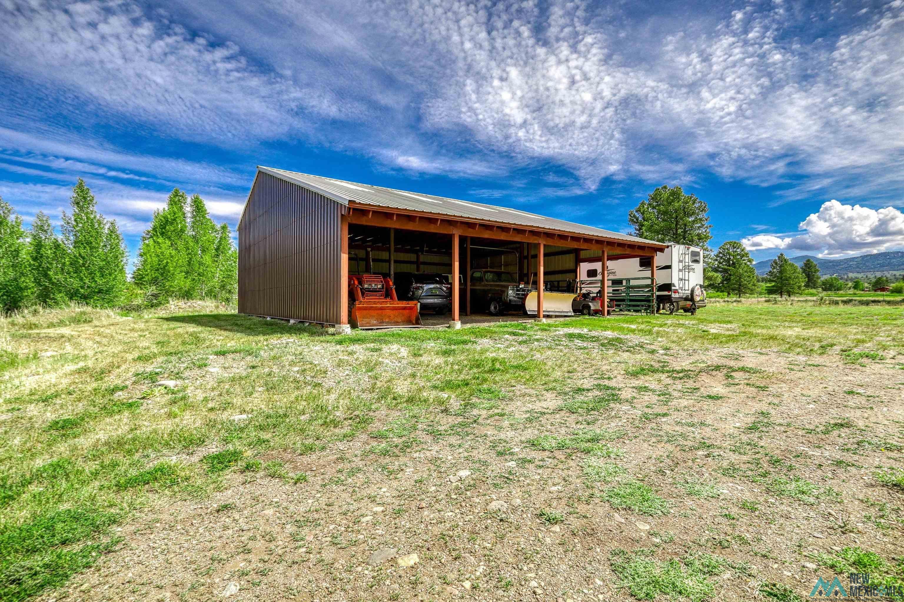 31 Cr 343 Road Chama, NM 87520 - Photo 38 of 44 View of pole building featuring a carport and a lawn