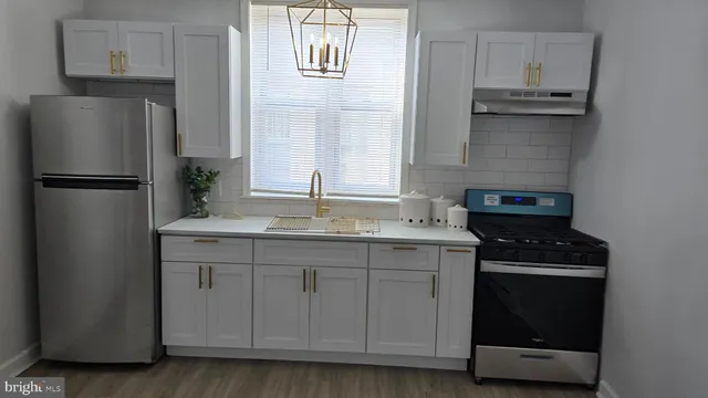 a kitchen with a refrigerator and a stove