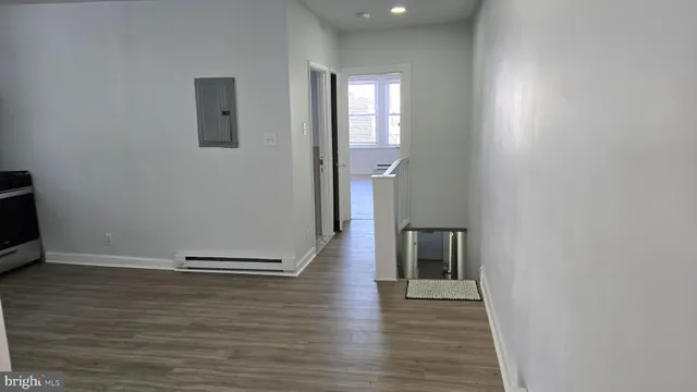 a view of a room with wooden floor