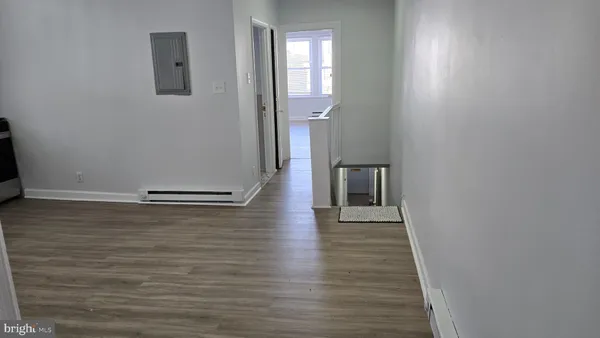 a view of a hallway with wooden floor