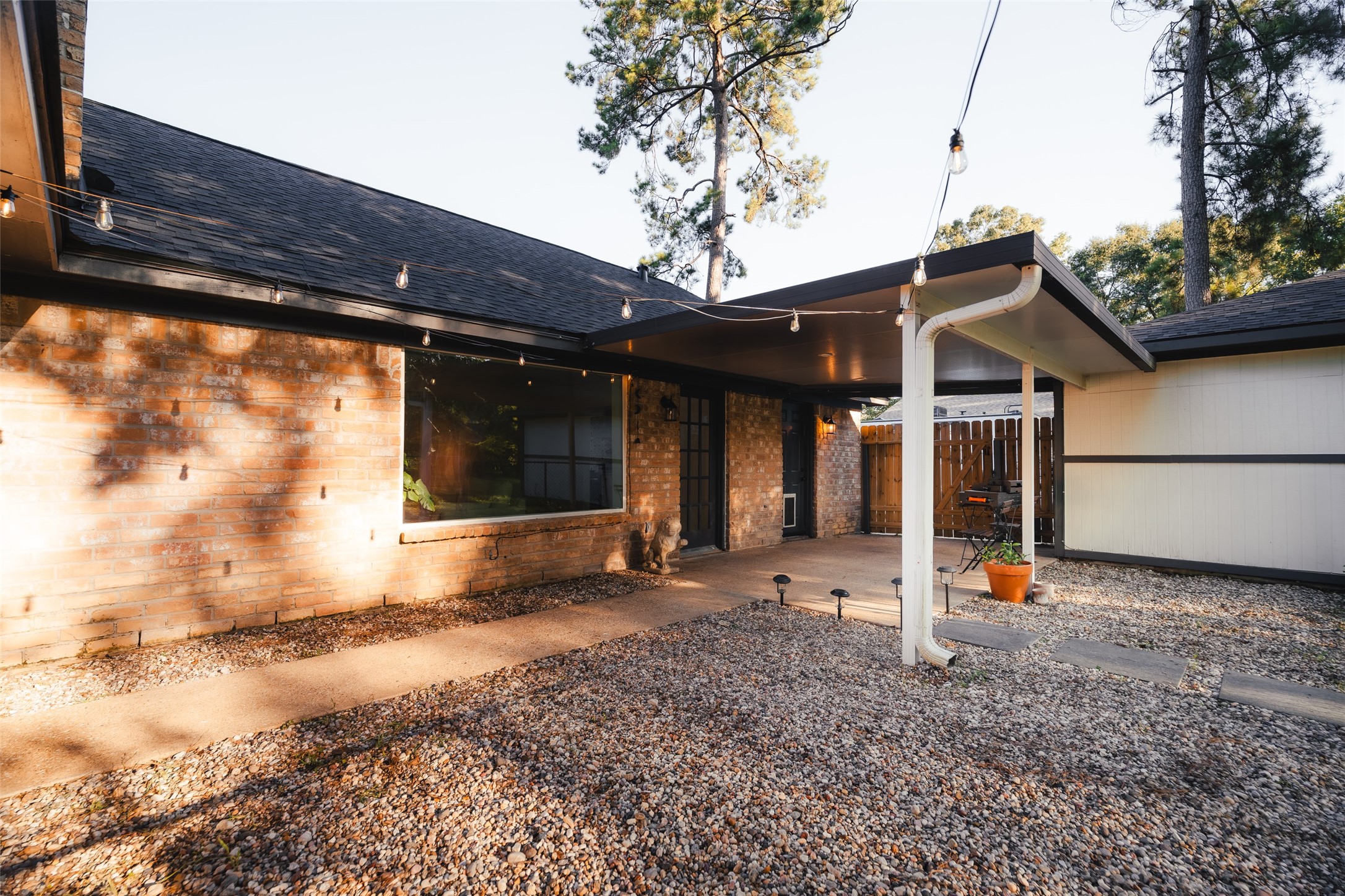 419 Magnolia Bend New Caney, TX 77357 - Photo 23 of 25 a view of a house with a large window and wooden fence