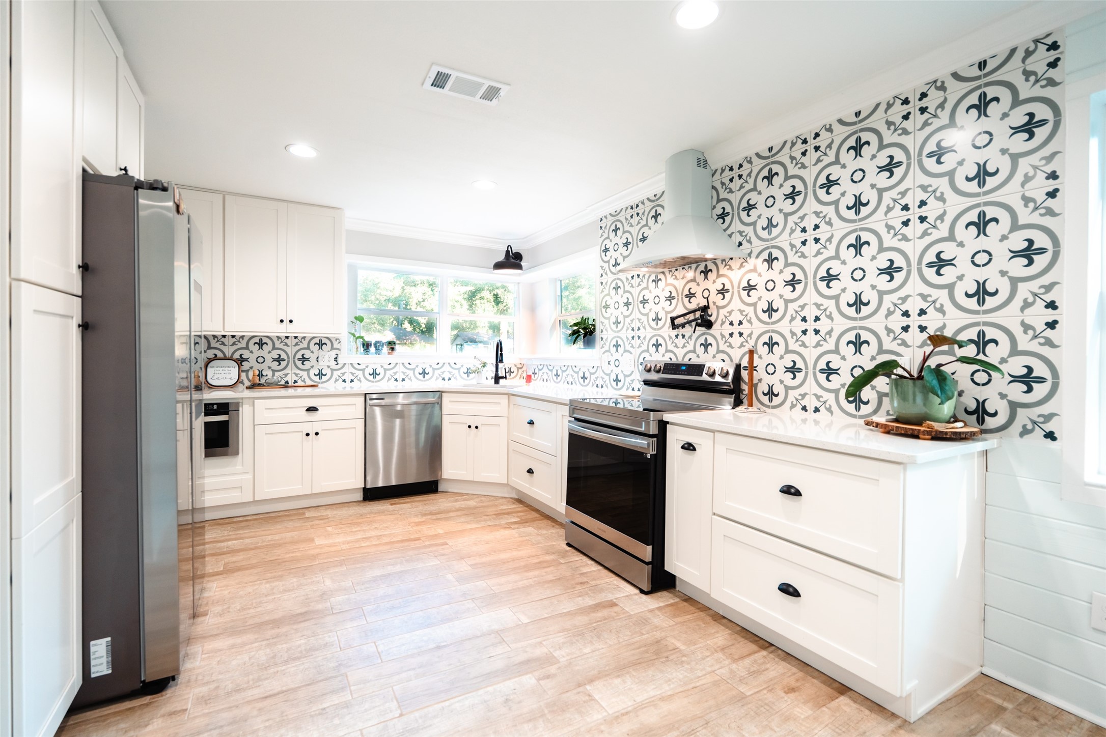 419 Magnolia Bend New Caney, TX 77357 - Photo 7 of 25 a kitchen with stainless steel appliances a stove a sink and a refrigerator