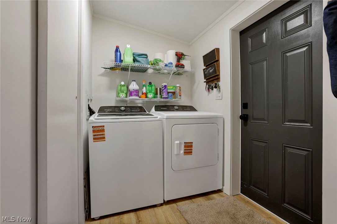 3750 Cannelville Road Roseville, OH 43777 - Photo 8 of 33 Laundry room featuring crown molding, light wood finished floors, and washer and clothes dryer