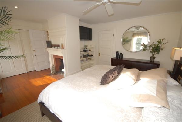43 Bartlet Street Andover, MA 01810 - Photo 15 of 30 a bedroom with a bed a mirror and a chandelier