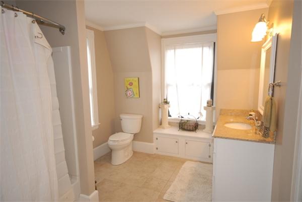 43 Bartlet Street Andover, MA 01810 - Photo 19 of 30 a bathroom with a sink a toilet and shower curtain