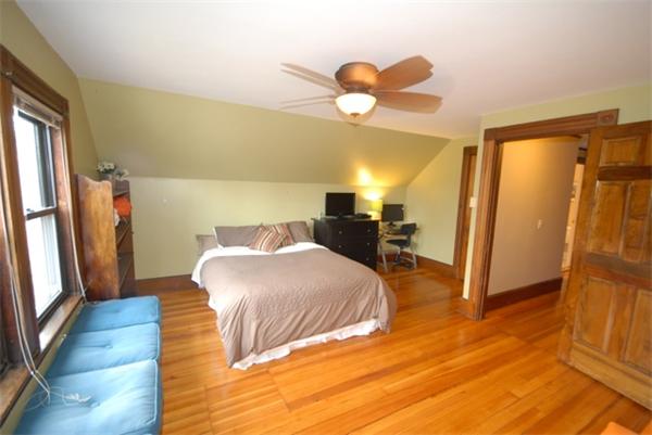 43 Bartlet Street Andover, MA 01810 - Photo 20 of 30 a bedroom with a bed and wooden floor