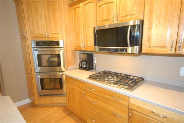 43 Bartlet Street Andover, MA 01810 - Photo 3 of 30 a kitchen with granite countertop a stove and a microwave