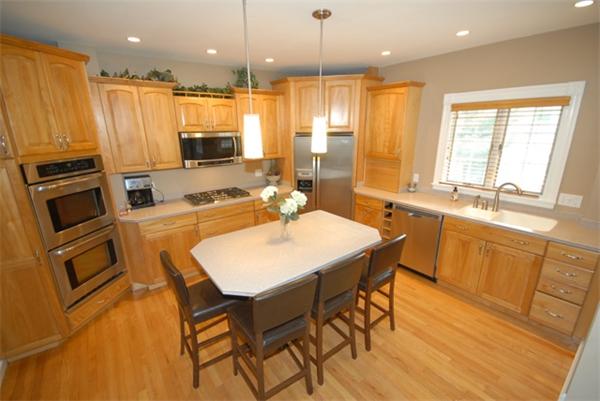 43 Bartlet Street Andover, MA 01810 - Photo 4 of 30 a kitchen with a table chairs sink and microwave