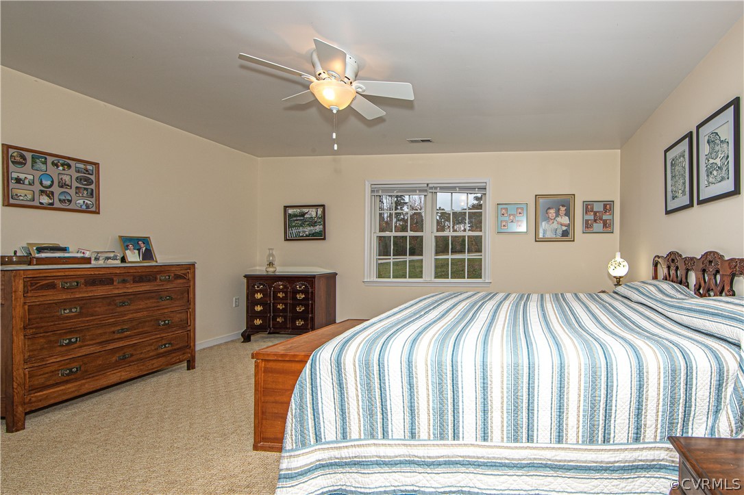 24410 Johnson Road Jetersville, VA 23083 - Photo 14 of 47 a bedroom with a bed and a chandelier