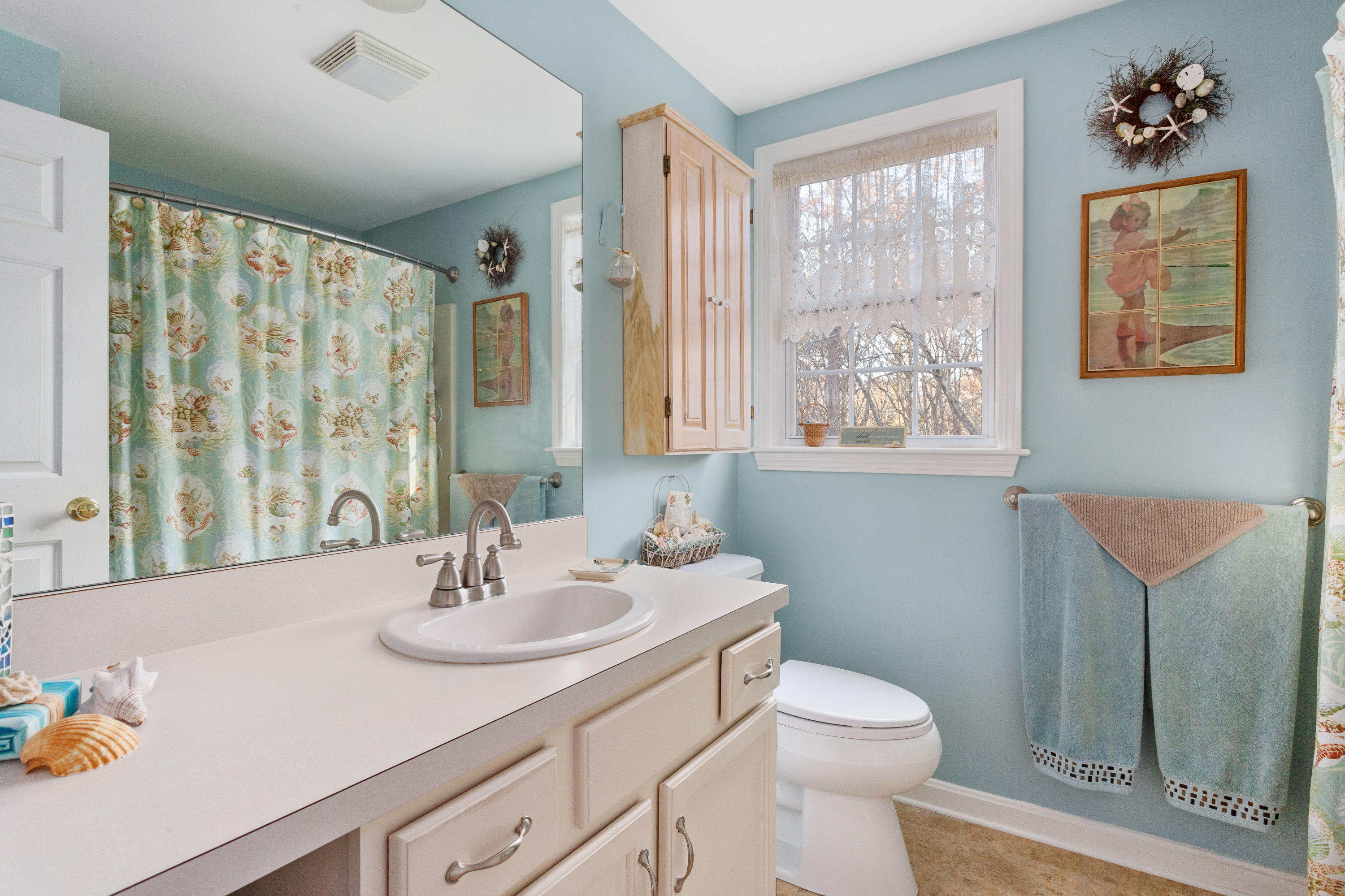 70 South Precinct Road Centerville, MA 02632 - Photo 19 of 32 a bathroom with a sink toilet and a mirror