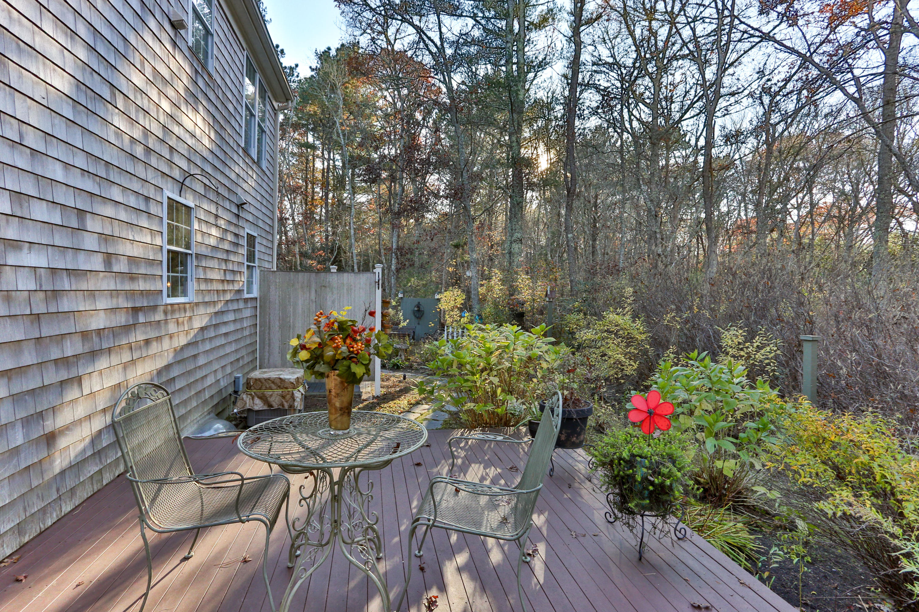 70 South Precinct Road Centerville, MA 02632 - Photo 28 of 32 a view of a chairs and table in a backyard