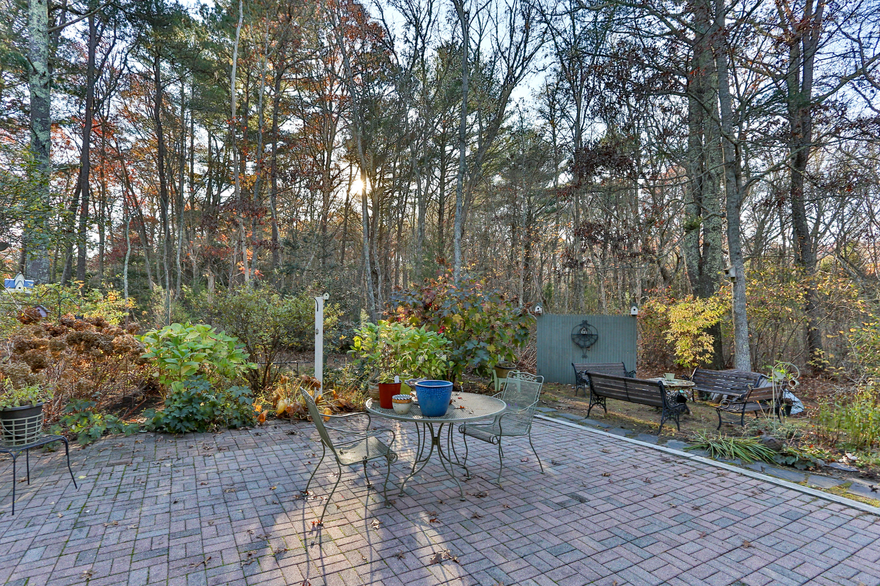 70 South Precinct Road Centerville, MA 02632 - Photo 29 of 32 a backyard with chairs and a table