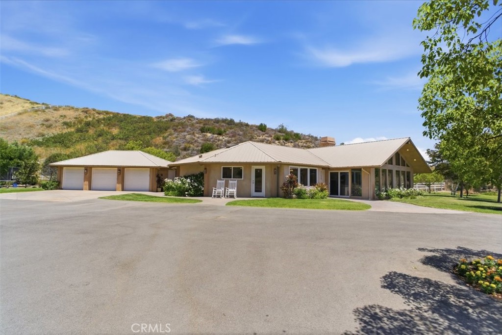 31233 Romero Canyon Road Castaic, CA 91384 - Photo 31 of 38 a front view of a house with a yard and garage