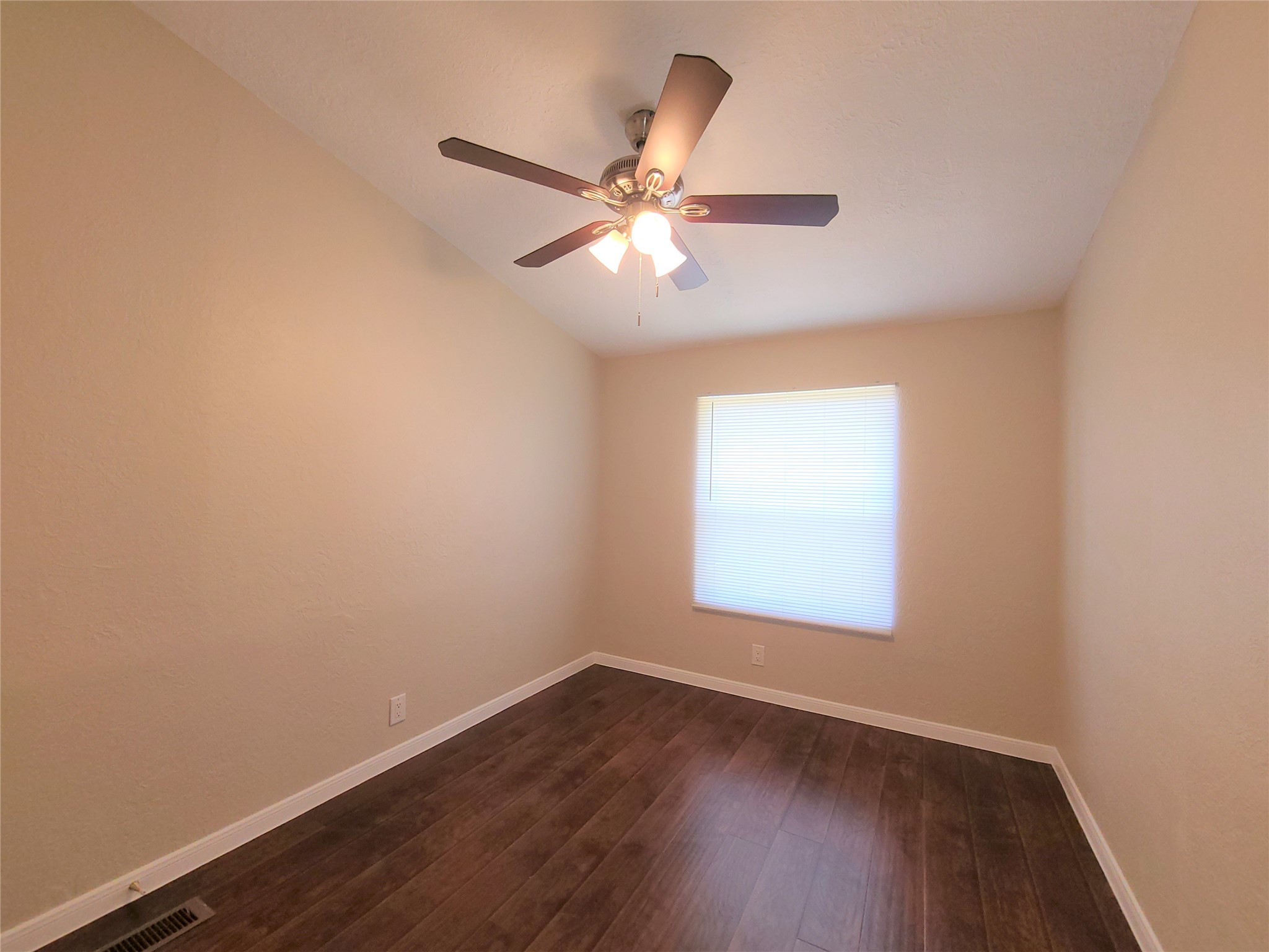 5414 Five Oaks Drive Spring, TX 77389 - Photo 10 of 13 an empty room with wooden floor fan and windows