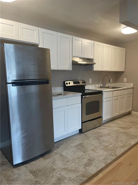 1045 Old Colony Road, Unit 12 Meriden, CT 06451 - Photo 1 of 1 a kitchen with stainless steel appliances granite countertop a refrigerator a stove a sink and cabinets