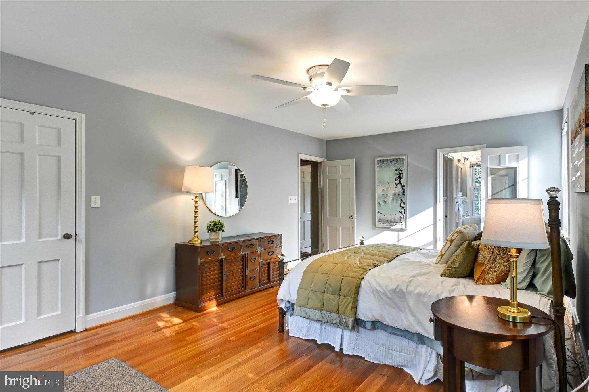 605 Worcester Road Towson, MD 21286 - Photo 20 of 39 a bedroom with a bed and dresser with mirror