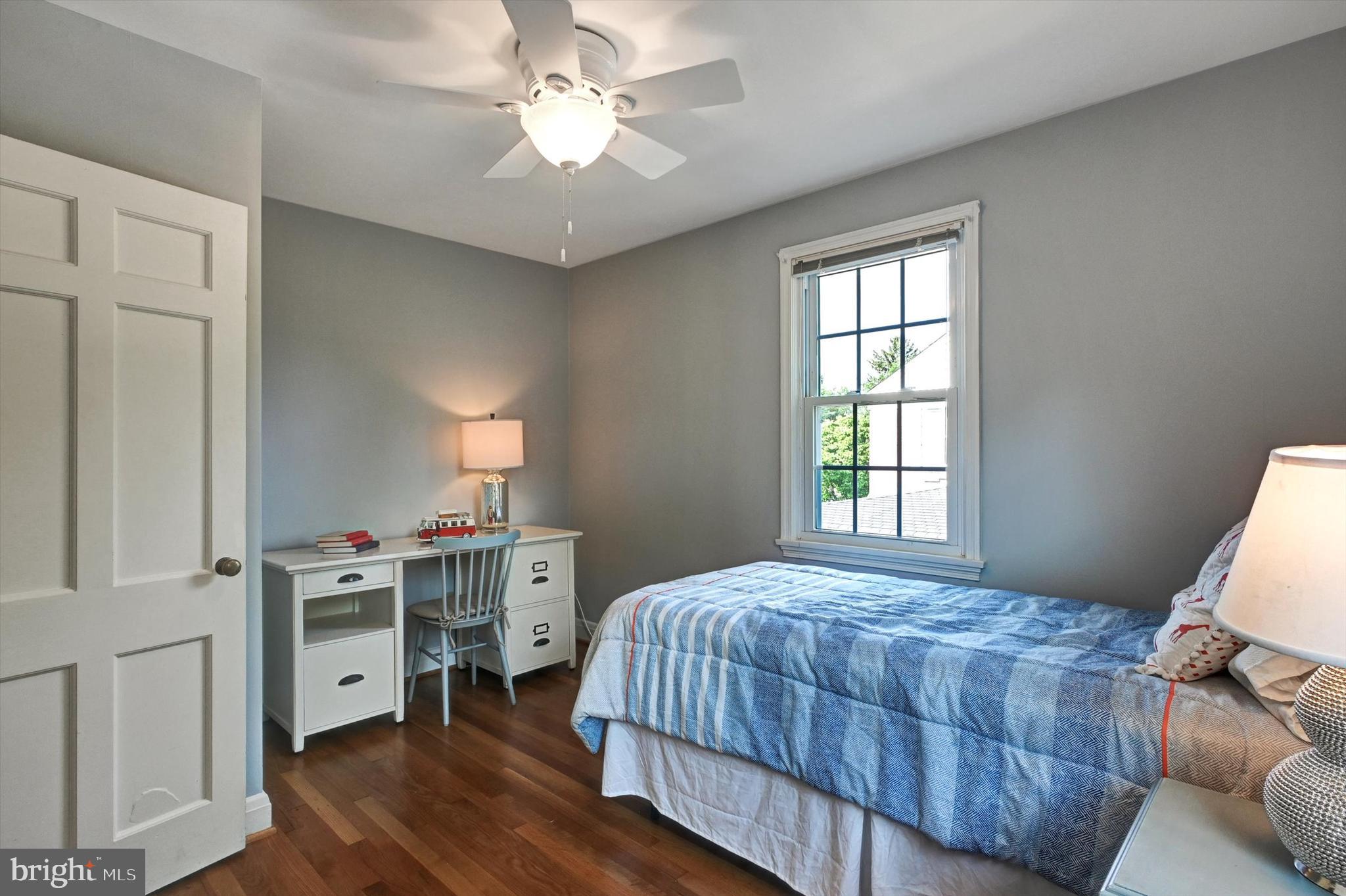 605 Worcester Road Towson, MD 21286 - Photo 23 of 39 a bedroom with a bed and a chandelier