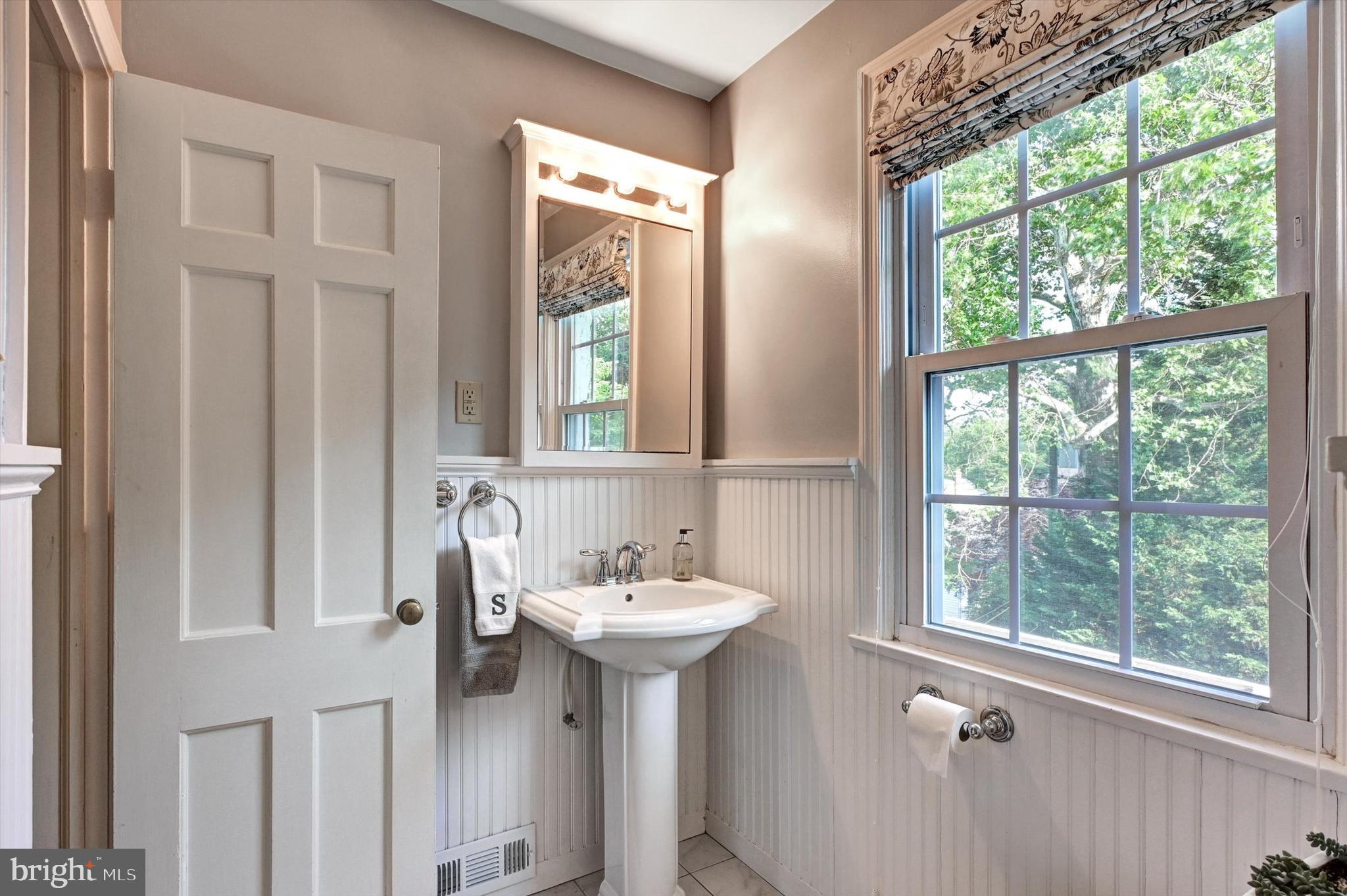 605 Worcester Road Towson, MD 21286 - Photo 25 of 39 a bathroom with a sink a mirror and a window
