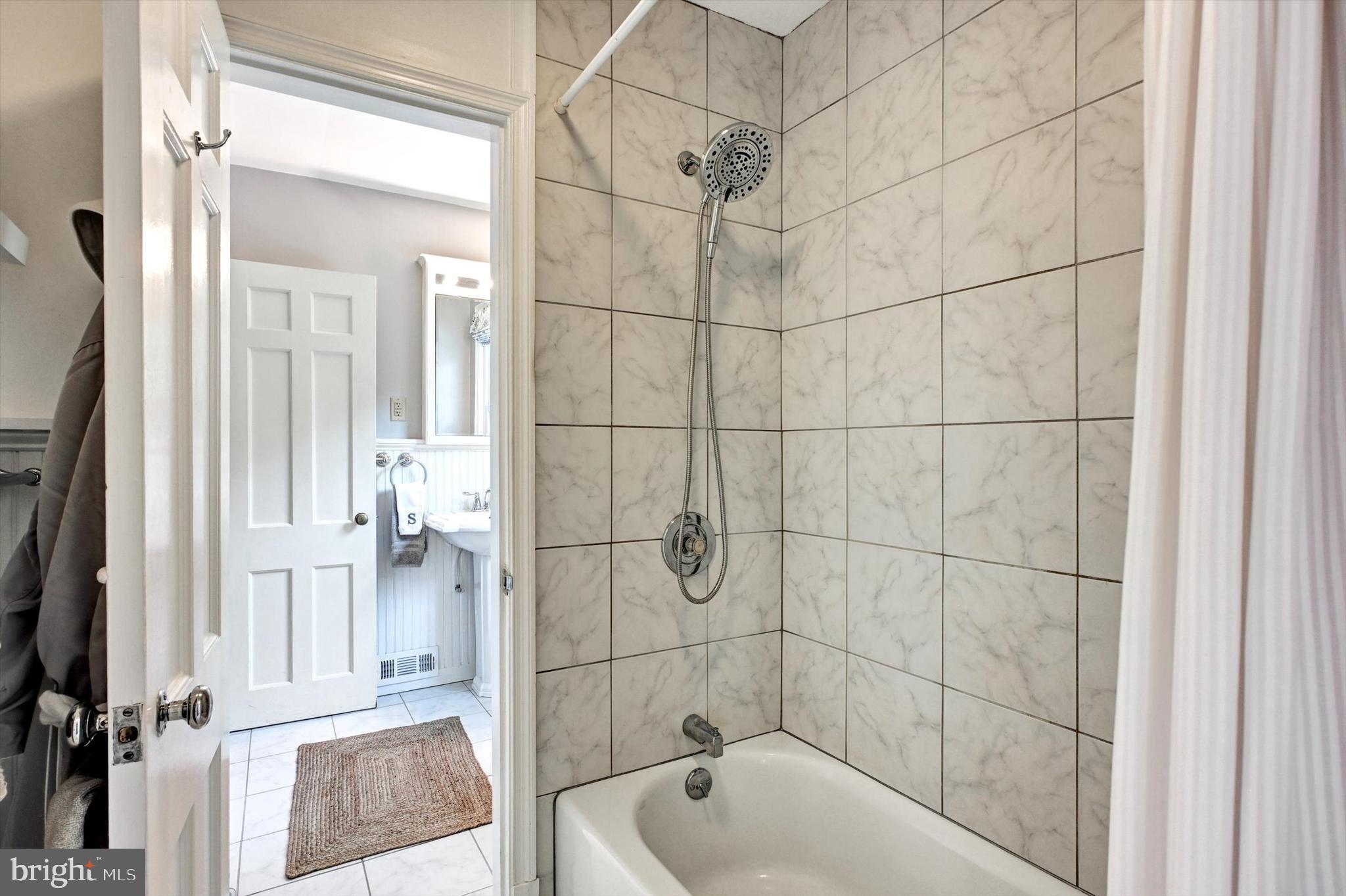 605 Worcester Road Towson, MD 21286 - Photo 26 of 39 a bathroom with a bathtub and a shower