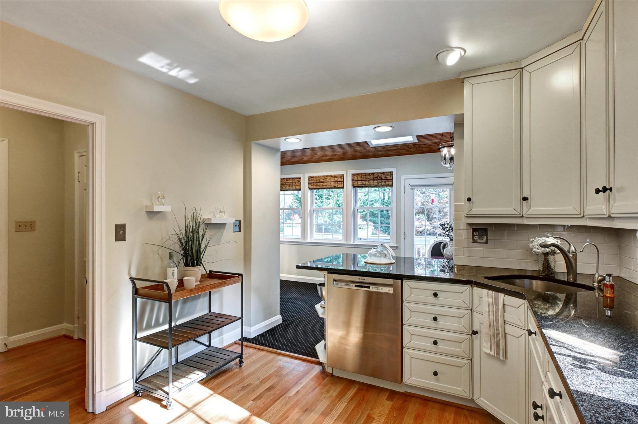 605 Worcester Road Towson, MD 21286 - Photo 10 of 39 a kitchen with granite countertop a sink cabinets stainless steel appliances and a window