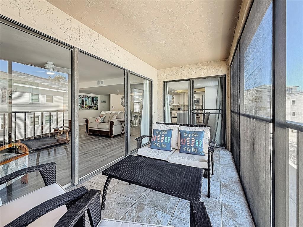 19725 Gulf Boulevard, Unit 46 Indian Rocks Beach, FL 33785 - Photo 12 of 55 a living room with furniture and a table