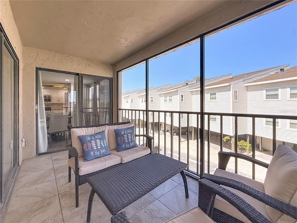 19725 Gulf Boulevard, Unit 46 Indian Rocks Beach, FL 33785 - Photo 12 of 55 a view of a porch with furniture