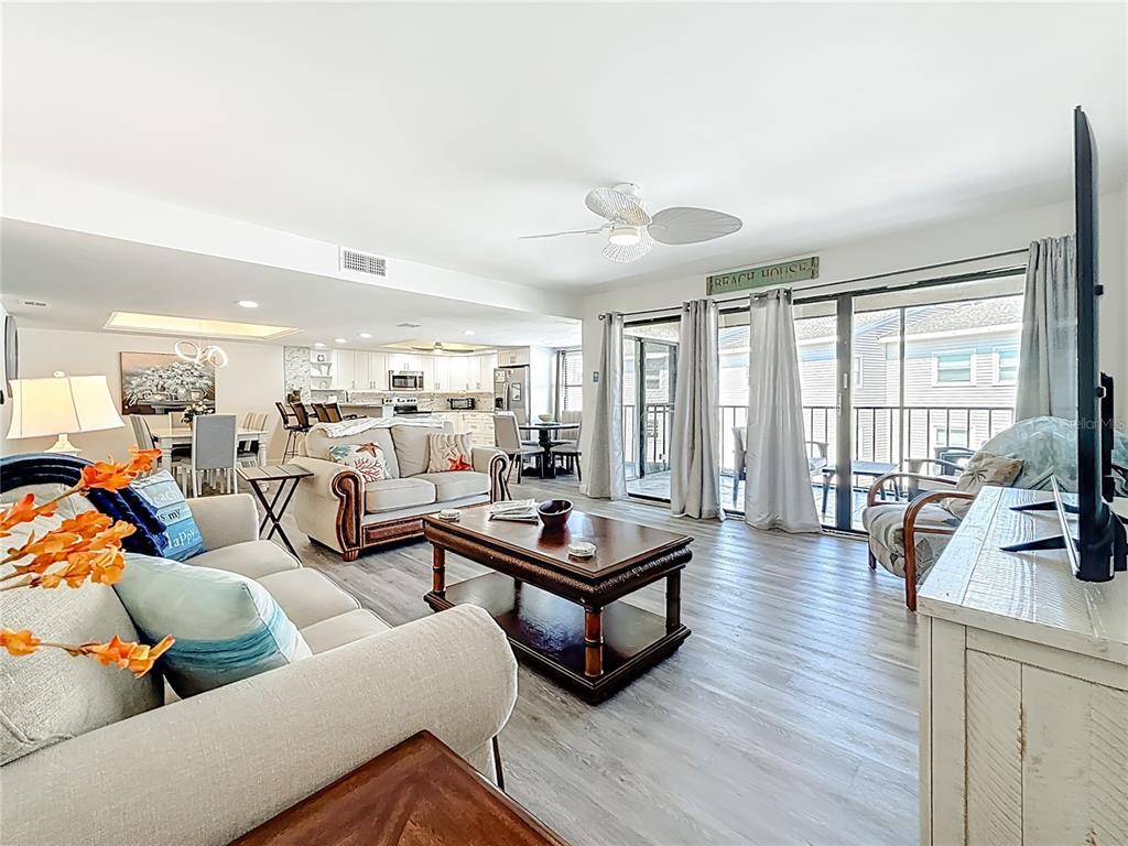 19725 Gulf Boulevard, Unit 46 Indian Rocks Beach, FL 33785 - Photo 2 of 55 a living room with furniture and a flat screen tv with wooden floor