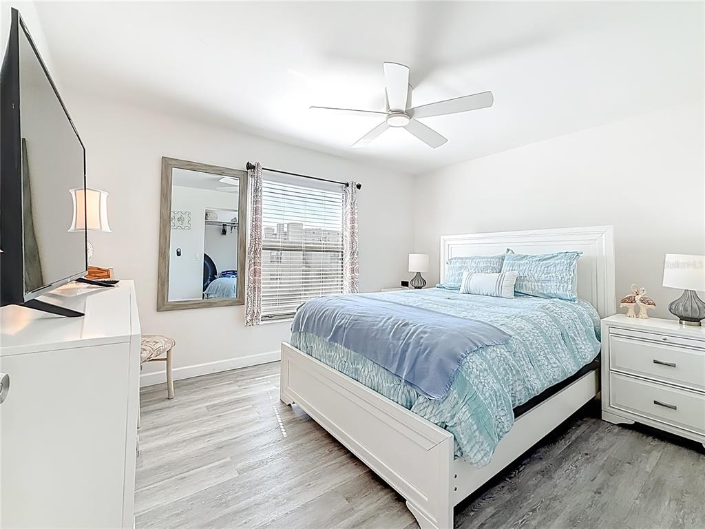 19725 Gulf Boulevard, Unit 46 Indian Rocks Beach, FL 33785 - Photo 23 of 55 a spacious bedroom with a large bed and a chandelier