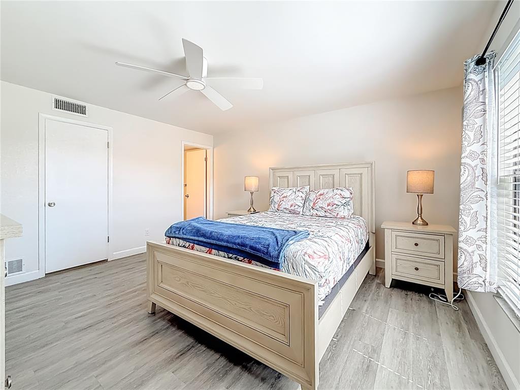 19725 Gulf Boulevard, Unit 46 Indian Rocks Beach, FL 33785 - Photo 26 of 55 a spacious bedroom with a bed and wooden floor