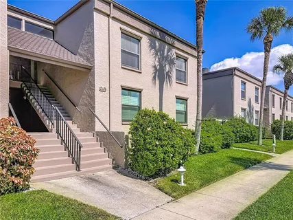 a view of a house with pool and chairs