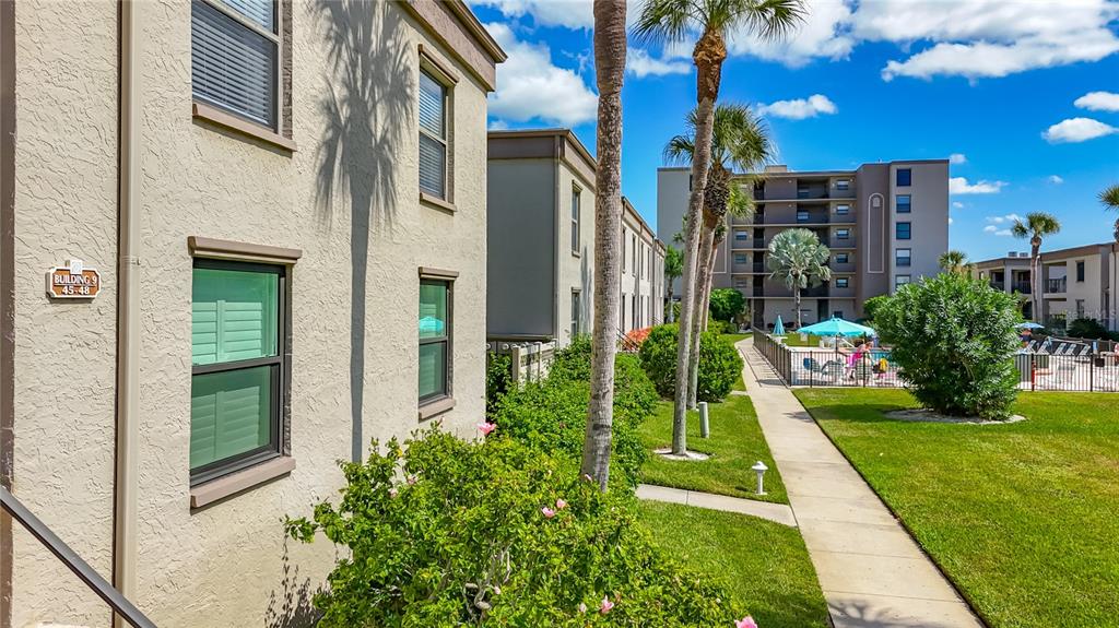 19725 Gulf Boulevard, Unit 46 Indian Rocks Beach, FL 33785 - Photo 35 of 55 a view of a multi story building with a yard