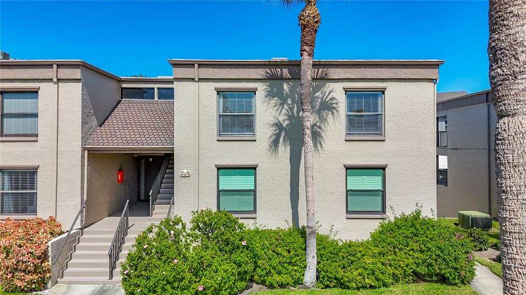 19725 Gulf Boulevard, Unit 46 Indian Rocks Beach, FL 33785 - Photo 36 of 55 a front view of a house with a yard